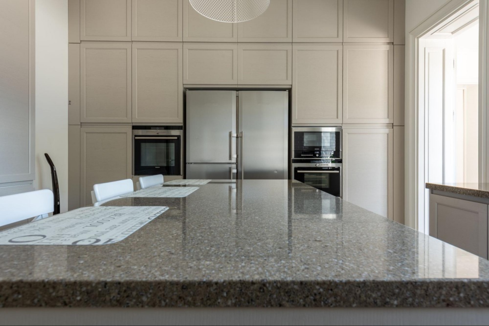 marble worktops and white cupboards in modern kitchen